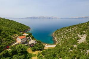 an aerial view of a house on the shore of a lake at Dora Apartment in Senj