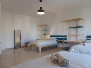a room with two beds and a mirror at Oberdan Guest House in Bari