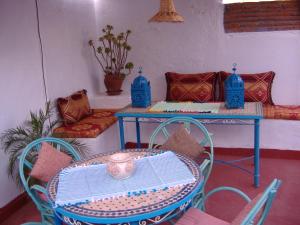 a table and chairs in a room with a table and a table and a table at Casa La Palma in Chefchaouene +35 photos
