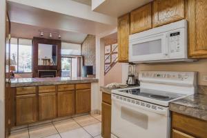 a kitchen with white appliances and wooden cabinets at Family Friendly Condo - Park City (Sleeps 8+) in Park City