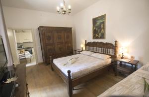 a bedroom with a large bed and two night stands at Appartamento Stibbert in Florence