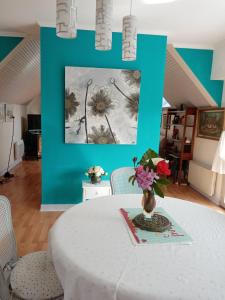 a table with a vase of flowers on top of it at la frégate blanche in Concarneau