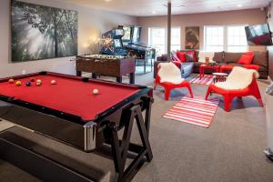 a living room with a pool table and a couch at 506 On the River Inn Woodstock in Woodstock