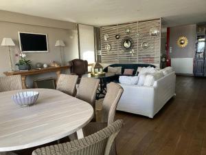 a living room with a white couch and a table at Villa Bikini in Quiberon