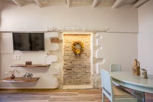a dining room with a brick wall and a table at Ariadne Luxury Home in Chania Town
