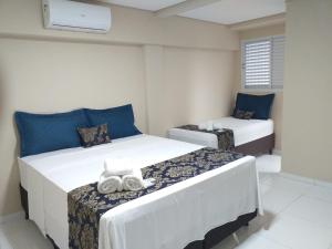 two beds in a room with blue and white at HOTEL LA SIERRA in Bodoquena +58 photos