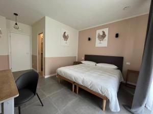 a bedroom with a bed and a desk and a chair at I Cappuccini wellness in Varzi