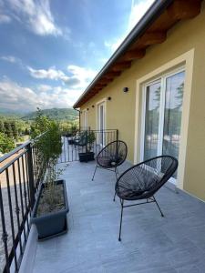 a patio with two chairs and a balcony at I Cappuccini wellness in Varzi