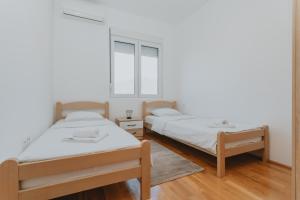 Ein Bett oder Betten in einem Zimmer der Unterkunft Apartments Bella Rosa