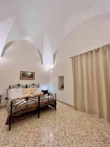 a bedroom with a bed in a white room at camera matrimoniale centro storico Galatina in Galatina