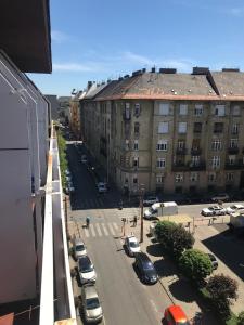 a city street with cars parked in a parking lot at Roland apartment WestND in Budapest