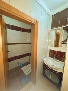 a bathroom with a sink and a mirror at LUSTRA GARDEN SUİTE in Trabzon