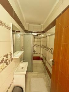 a small bathroom with a sink and a shower at LUSTRA GARDEN SUİTE in Trabzon