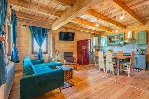 a living room with a blue couch and a table at Casa WEZLY in Măgura