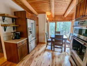 a kitchen and dining room with a table in a cabin at Jackson Hole Hideout in Wilson