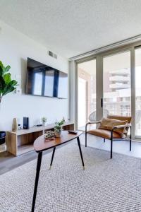 a living room with a table and a couch at Exquisite 1 Bedroom Condo At Ballston With Gym in Arlington