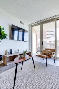 a living room with a table and a couch at Bright Apartment Walk to Ballston Metro in Arlington