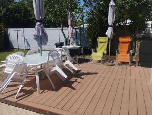 a group of chairs and a table and umbrella at Le petit viry in Viry-Châtillon