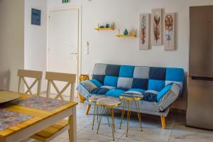 
a living room filled with furniture and a refrigerator at Albertoshouse in Skiathos Town
