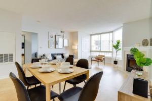 a dining room and living room with a table and chairs at Fantastic 2 Bedroom Condo At Ballston With Gym in Arlington