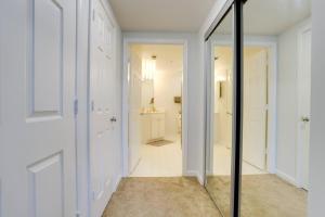 a hallway with a glass door and a bathroom at Fantastic 2 Bedroom Condo At Ballston With Gym in Arlington +46 photos