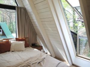 a bedroom with a bed in front of a window at Domek Modern BRDA in Nysa