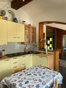 a kitchen with a table in the middle of it at Relax in Valle D'Aosta da B&G in Aosta