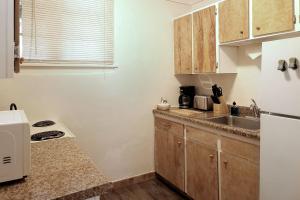 a kitchen with wooden cabinets and a sink at Ocean Terrace Condominiums in Lincoln City