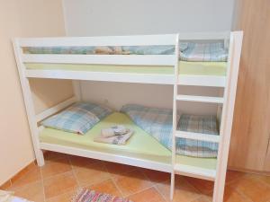 a white bunk bed with four bunk beds in a room at Studio Apartman Marti in Kostrena