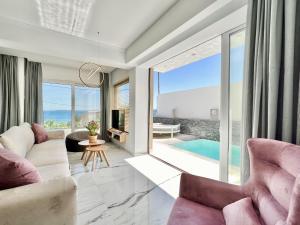 a living room with a view of the ocean at Luxury Villa Barbati Sun with private pool by DadoVillas in Barbati