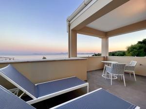 a balcony with a view of the ocean at Luxury Villa Barbati Sun with private pool by DadoVillas in Barbati