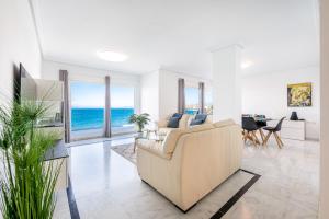 a living room with a couch and a view of the ocean at KEYWISE Beachhouse OceanBlue in Benalmádena