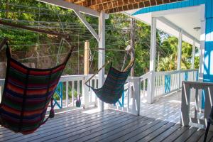 two hammocks hanging on the porch of a house at Bliss on the Bay family in West End