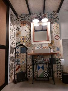 a bathroom with a sink and a mirror on a wall at Apartamentos La Florida in Arrecife