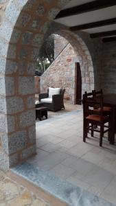 a stone archway with a bench and a table at Mani Fort Charabos in Ayía Kiriakí