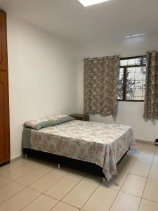 a bedroom with a bed and a window at Morada da Lua in Foz do Iguaçu +17 photos