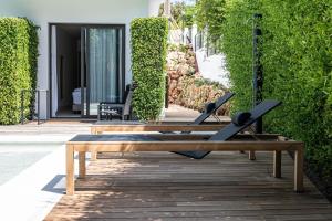 a wooden bench sitting on top of a patio at Casa Bodhi Boutique Hotel & Spa in Marbella