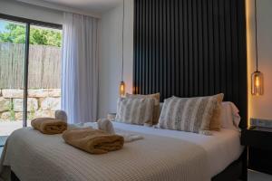 a bedroom with a bed with towels on it at Casa Bodhi Boutique Hotel & Spa in Marbella