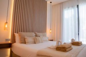 a bedroom with two towels on a bed with a window at Casa Bodhi Boutique Hotel & Spa in Marbella
