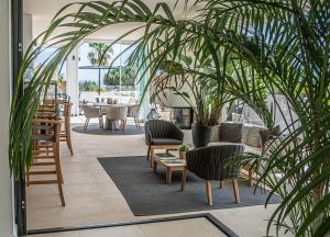 a patio with chairs and tables and plants at Casa Bodhi Boutique Hotel & Spa in Marbella