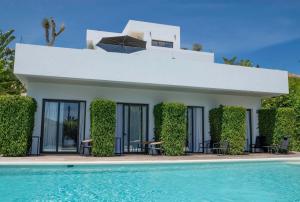 a villa with a swimming pool in front of it at Casa Bodhi Boutique Hotel & Spa in Marbella