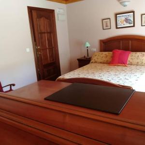 a bedroom with a bed with a laptop on a table at hotel el candano in Pravia