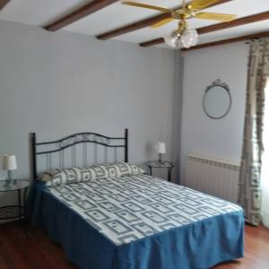 a bedroom with a bed and a ceiling fan at hotel el candano in Pravia