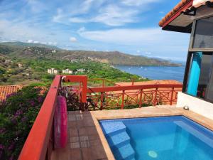 a balcony with a swimming pool and a view of the ocean at Hermosa Beach Villa w/Pool & Amazing Views in Playa Hermosa