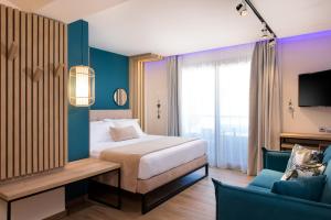 a hotel room with a bed and a couch at SKS Luxury Suites & Rooms in Paralia Katerinis +36 photos