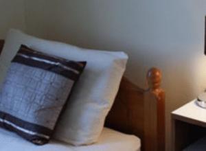 a black and white pillow sitting on top of a bed at Wards Hotel in Galway