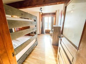 a bedroom with a bunk bed and a wooden door at Private Mountain Cabin! King Bed 8 Acres Game Rm in Eastonville