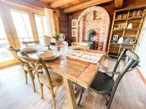 a dining room with a table and a brick oven at Private Mountain Cabin! King Bed 8 Acres Game Rm in Eastonville +14 photos