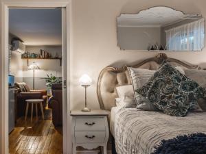 a bedroom with a bed and a table with a mirror at Aldgate Valley Bed and Breakfast in Aldgate