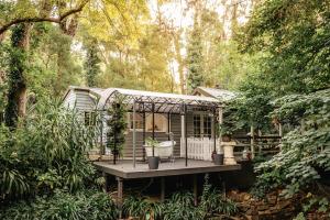 a tiny house in the middle of a forest at Aldgate Valley Bed and Breakfast in Aldgate